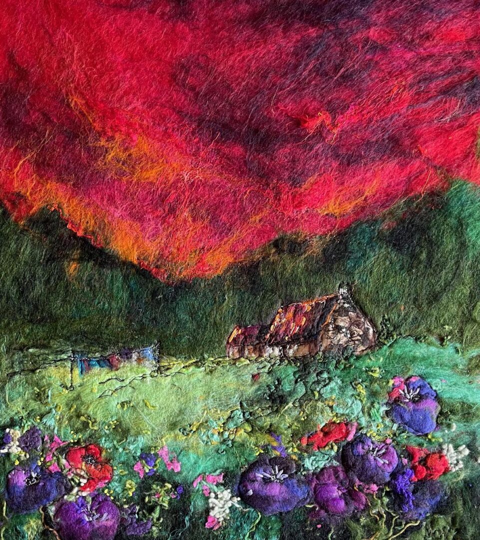Vivid textile art depicting a rustic cabin under a dramatic red and orange sky, surrounded by lush greenery and vibrant purple flowers.